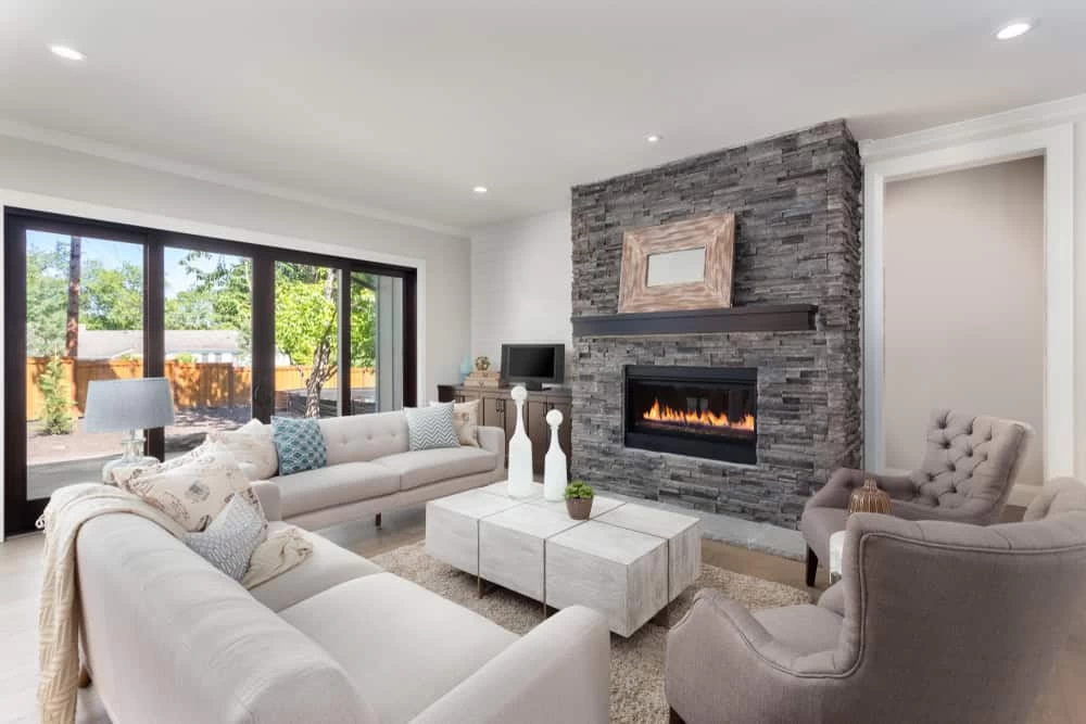 Modern living room after home remodeling in Contra Costa County with fireplace and cozy couches