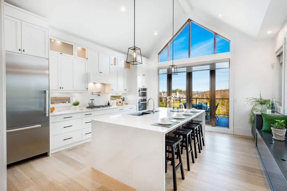 A kitchen with a large island and a view of the outdoors in Contra Costa County, CA.