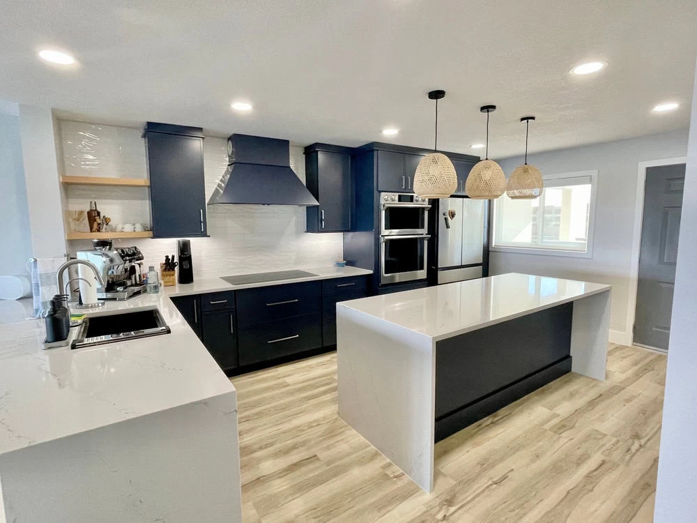 A kitchen with blue cabinets and white counter tops in Contra Costa County, CA.