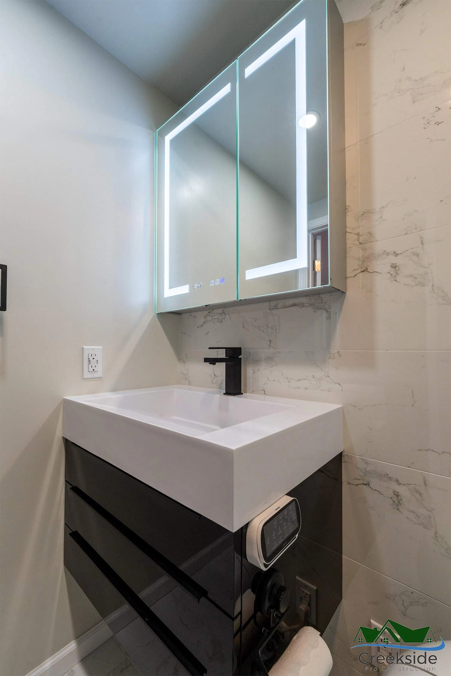 A shower with a black and white marble wall in Contra Costa County, CA.