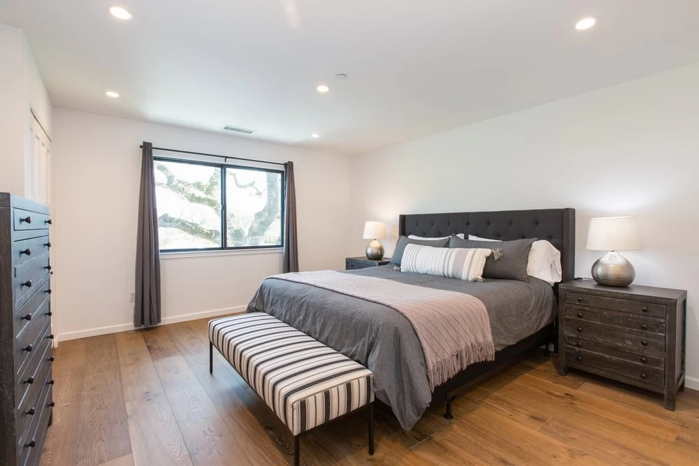 A bedroom with a bed, dresser and nightstands in Contra Costa County, CA.