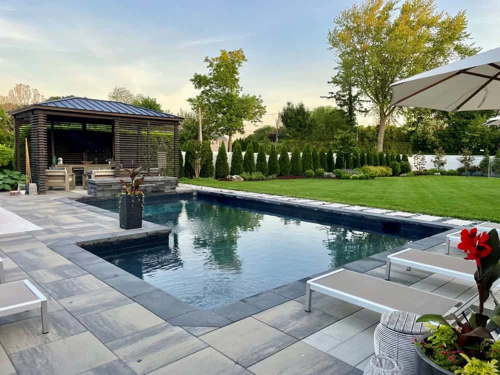L-shaped backyard pool with plunge and sun deck in a high-end home remodeling project in Contra Costa County