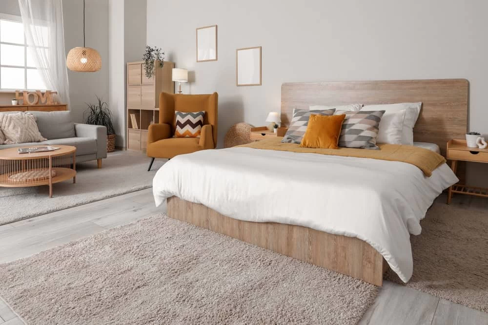 A modern bedroom with a bed, chair and table in Contra Costa County, CA.