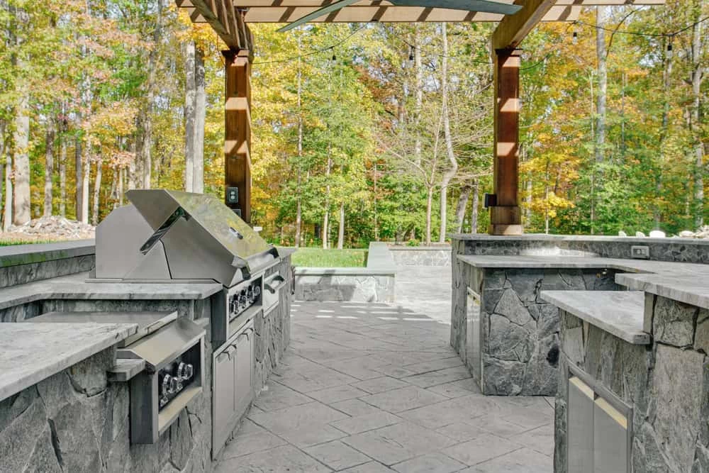 Inviting partially covered outdoor patio with stone kitchen island in Contra Costa County home remodeling project.