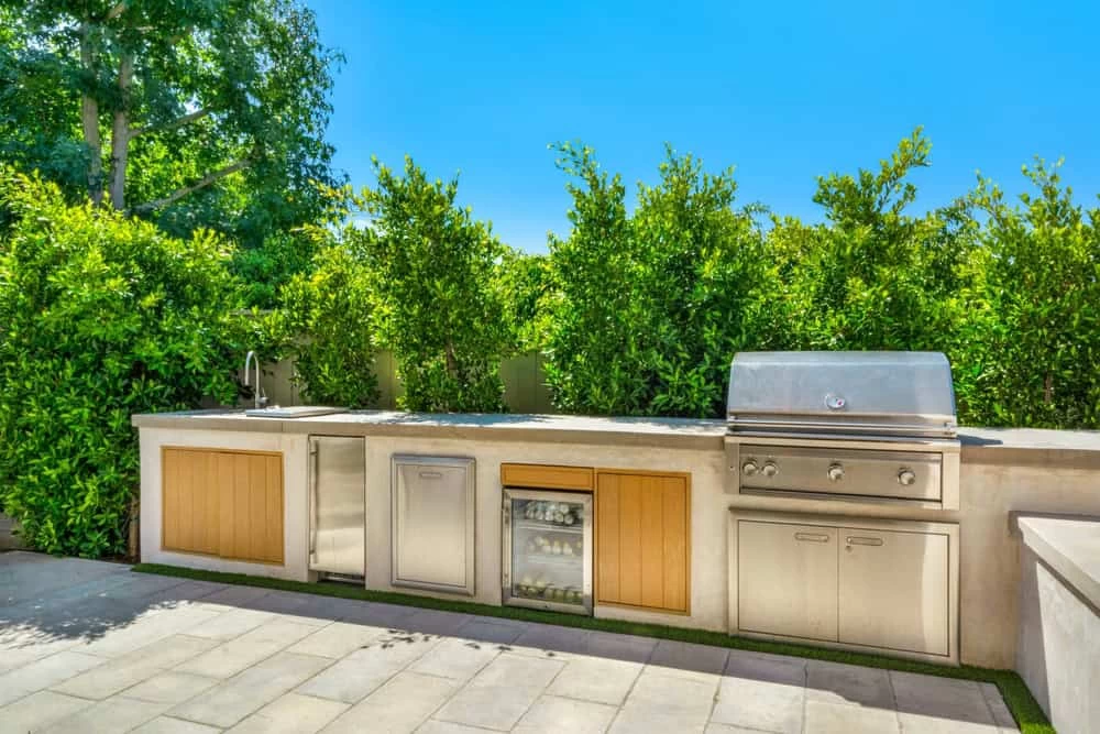 Inviting partially covered outdoor patio with stone kitchen island in Contra Costa County home remodeling project.