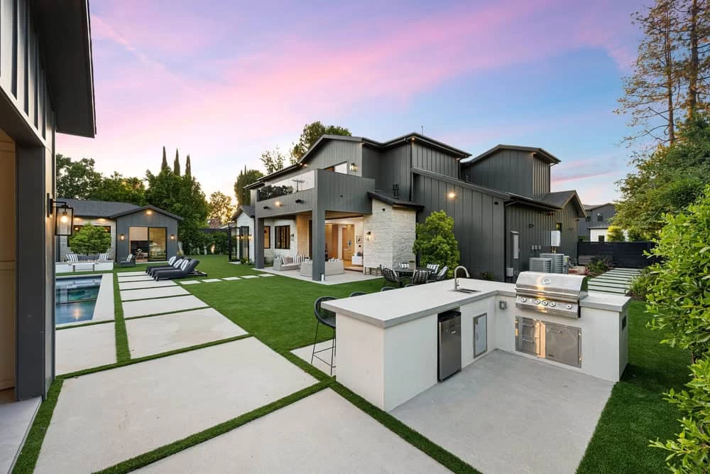 Modern backyard with outdoor kitchen, pool, and lounge area – home remodeling in Contra Costa County